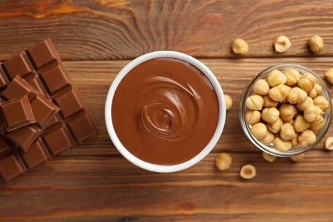 Chocolate paste with a bowl on a table. Stock Photos