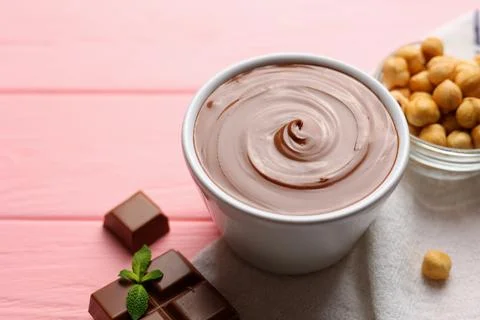 Chocolate paste with a bowl on a table. Stock Photos