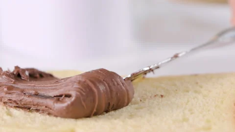 Chocolate paste. Chocolate hazelnut spread spread on fresh bread. Sweet toast Stock Footage 196123380