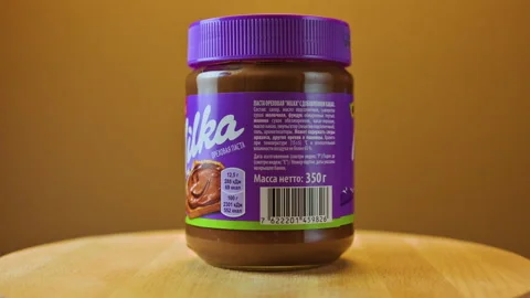 Chocolate paste with hazelnuts on a beautiful background Stock Footage 152604897