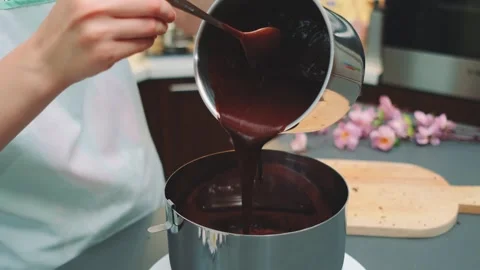 Chocolate paste is poured into a split mold on the cake Stock Footage 250338921