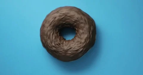 Chocolate pecan donut close-up macro shot spinning on a blue background Vídeo Stock 78077884