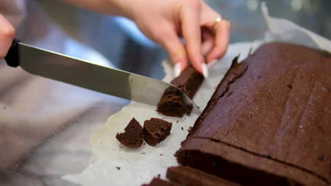 Chocolate pie hands cut chocolate cake pudding with nut crumbs into slices. Stock Footage 301289889