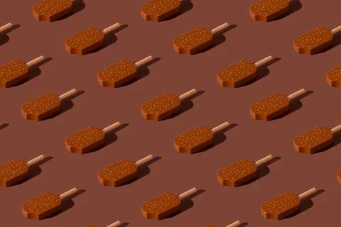 Chocolate popsicles pattern on a brown background. Stockfoto's