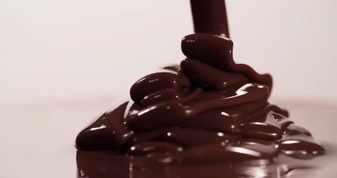 Chocolate is pouring on chocolate surface Close up Macro shot Slow motion Stock Footage 108811416