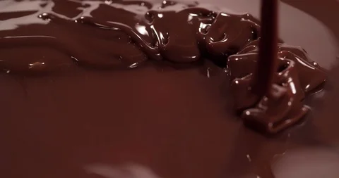 Chocolate is pouring on chocolate surface Close up Macro shot Stock Footage 108811650