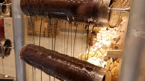 Chocolate pouring from machine with roller. Manufacturing chocolate. 動画素材 100110032