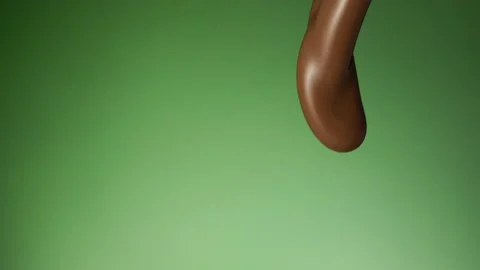 Chocolate pouring over flat background Stock Footage 149003461