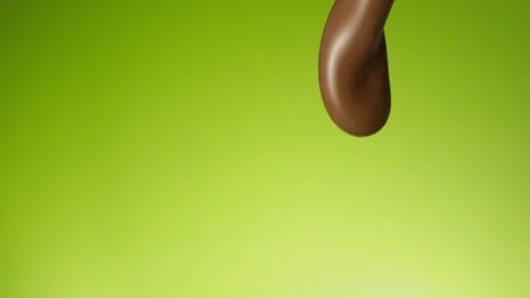 Chocolate pouring over flat background Stock Footage 149003549
