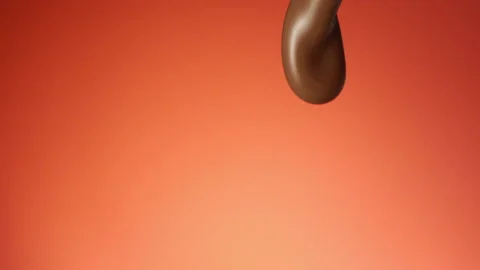 Chocolate pouring over flat background Stock Footage 149003554