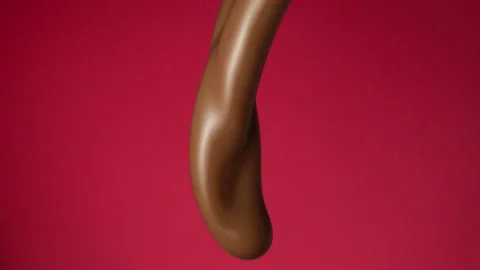 Chocolate pouring over flat background Stock Footage 149003635