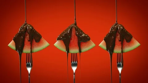 Chocolate pouring over watermelon triangular slices on red background 스톡 동영상 125449124