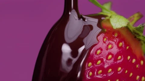 Chocolate pouring onto strawberry Stock Footage 155355716