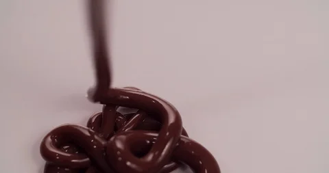 Chocolate is pouring on white surface Close up Macro shot Stock Footage 108814024
