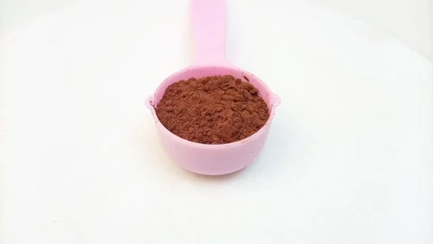 Chocolate Powder in Measuring Cup Moving on White Background, Cocoa Powder .. Stock Footage 340550756