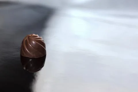 Chocolate pralines on black background . Stock Photos