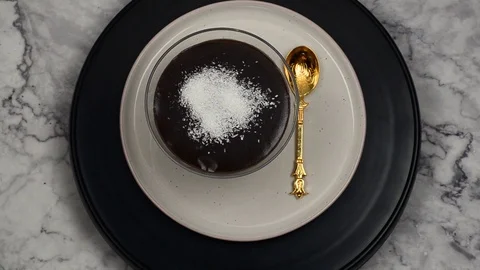 Chocolate pudding with coconuts. Top view in kitchen 動画素材 103805389