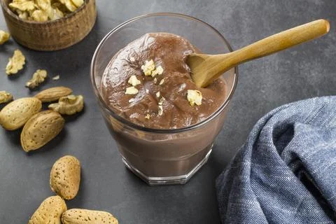 Chocolate pudding with different types of nuts Stock Photos