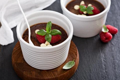 Chocolate pudding with raspberries and basil Stock Photos