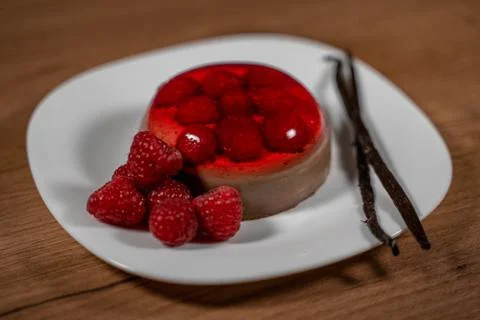 Chocolate pudding with raspberry jelly. Close-up image on wooden surface 스톡 사진