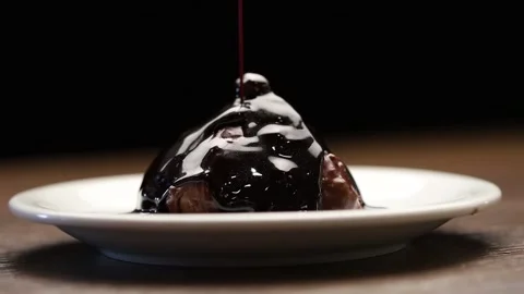 Chocolate pyramid with hazelnut and chocolate sauce Stock Footage 130452854
