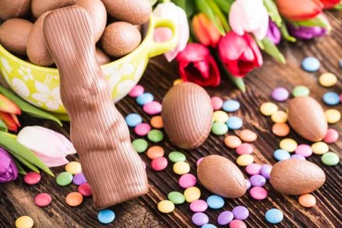 Chocolate rabbit, easter eggs and tulips Stock Photos