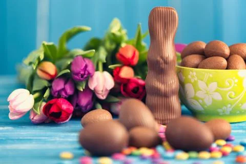 Chocolate rabbit, easter eggs and tulips Stock Photos
