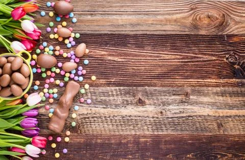 Chocolate rabbit, easter eggs and tulips Stock Photos