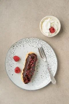 Chocolate raspberry eclair Stock Photos
