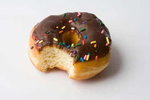 Chocolate ring donut with missing bite Stock Photos