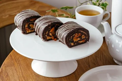 Chocolate roll with nuts on a stand Stock Photos