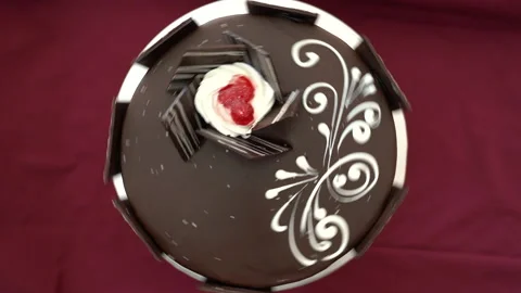 Chocolate round cake with white patterns on it, decorated with strawberries Stock Footage 234825600