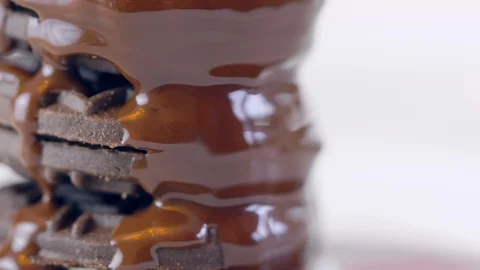 Chocolate sauce dripping over stack of cookies. Stock Footage 92145403