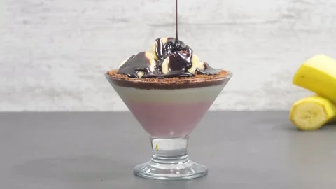 Chocolate sauce pouring over pudding Stock Footage 132277402