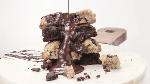 Chocolate Sauce Pouring Over A Stack Of Chocolate Chip Cookies - close up Video stock 157113110