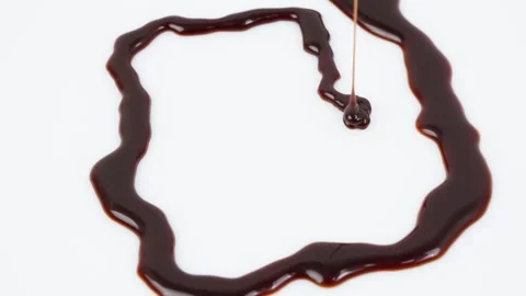 Chocolate Sauce Rotating on White Background Isolated Stock Footage 325349685
