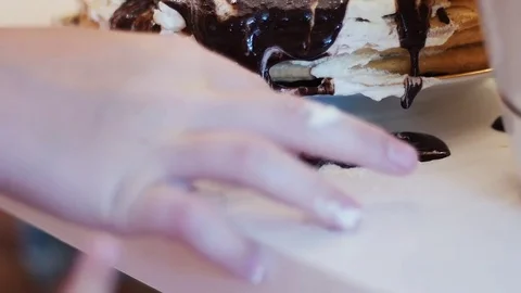 Chocolate slips away with cake on a table Stock Footage 78362248