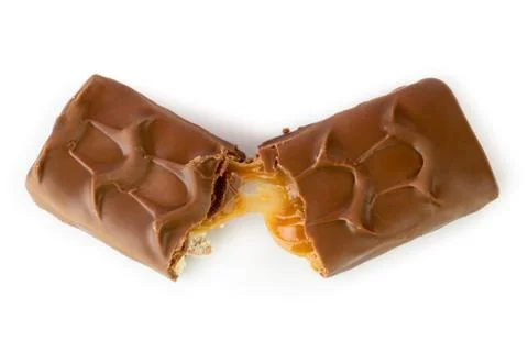 Chocolate Snickers broken in half on a white. The view from the top. Stock Photos