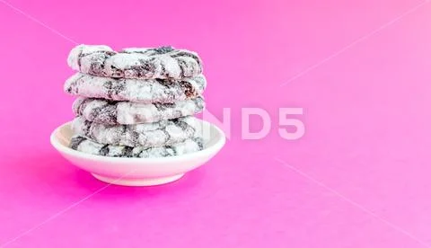 Chocolate snowy cookies on a pink background. Stock Photos