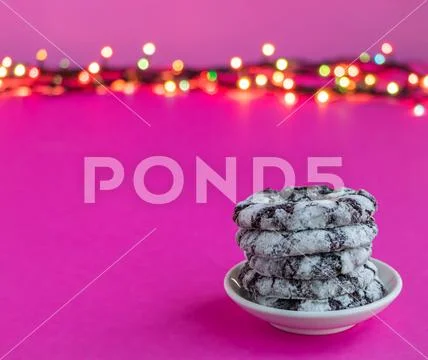 Chocolate snowy cookies on a pink background. Stock Photos