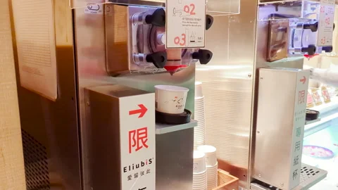 Chocolate Soft Serve Delight: Automatic Ice Cream Machine in Action at Buffet Video stock 303715767
