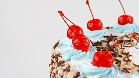 Chocolate sponge cake, decorated with red maraschino cherries Stock Footage 87175793