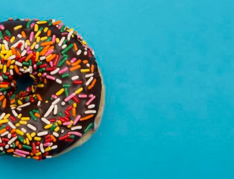 Chocolate Sprinkle Donuts on a Blue Background Foto stock