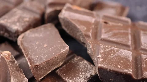 Chocolate square pieces on a dark surface Stock Footage 340942620
