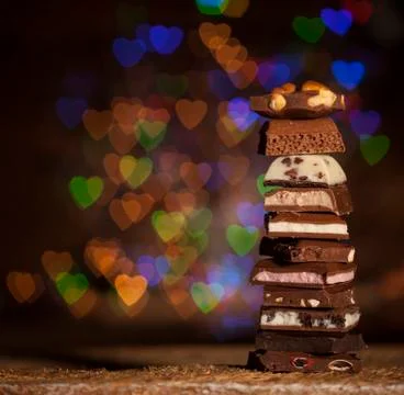 Chocolate stack on colorful bokeh background Stock Photos