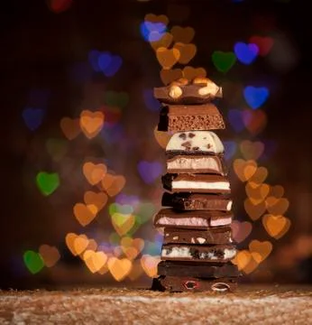 Chocolate stack on colorful bokeh background Stock Photos