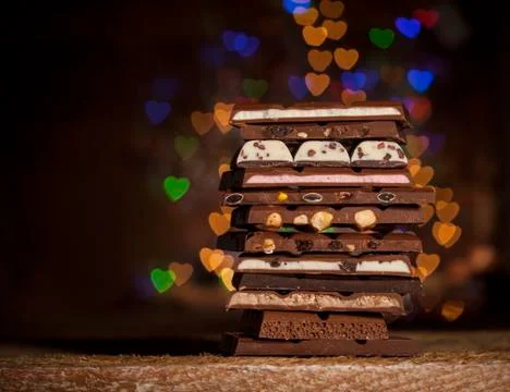 Chocolate stack on colorful bokeh background Stock Photos