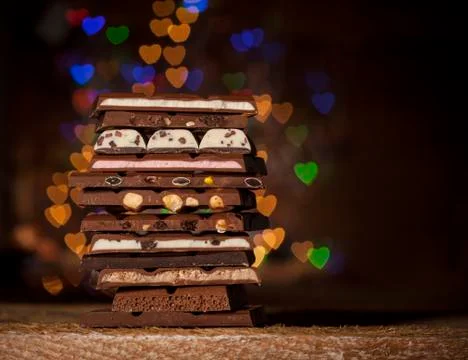Chocolate stack on colorful bokeh background Stock Photos