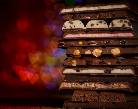 Chocolate stack on colorful bokeh background Stock Photos