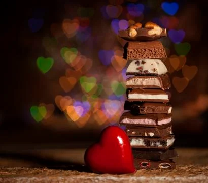 Chocolate stack on colorful bokeh background Stock Photos